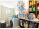 Well-organized laundry room with a front load washer/dryer and ample shelving for storage at 130 Masterpiece Rd, Lake Wales, FL 33898