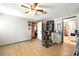 Spacious living room with ceiling fan, wood flooring, and a cat tree at 130 Masterpiece Rd, Lake Wales, FL 33898