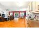 Open living room and kitchen with wood floors, large windows, and comfortable seating at 130 Masterpiece Rd, Lake Wales, FL 33898