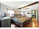 Bedroom with hardwood floors, ceiling fan and king sized bed at 130 Masterpiece Rd, Lake Wales, FL 33898