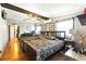 Spacious bedroom featuring wood floors, a ceiling fan, and decoratively exposed wood beam at 130 Masterpiece Rd, Lake Wales, FL 33898