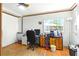 Bright office space with hardwood floors, a ceiling fan, a view to the outside, and ample room for a desk and storage at 130 Masterpiece Rd, Lake Wales, FL 33898