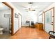 A versatile office area has hardwood floors, a ceiling fan, closet space, a view of a bathroom, and an exterior exit at 130 Masterpiece Rd, Lake Wales, FL 33898