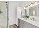 Bathroom featuring double sinks, modern fixtures, a glass shower, and ample counter space at 139 Douglas St, Edgewater, FL 32141