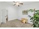 Bright bedroom with fan, carpet, decor, and a large houseplant at 139 Douglas St, Edgewater, FL 32141