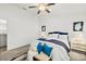 Bright bedroom with a ceiling fan, white walls, and a cozy bed with blue accents and carpet floors at 139 Douglas St, Edgewater, FL 32141