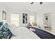 Light and airy bedroom featuring modern decor, large windows, and ensuite bathroom at 139 Douglas St, Edgewater, FL 32141