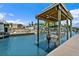 View of canal with boat lift and adjacent waterfront residences at 139 Douglas St, Edgewater, FL 32141