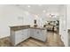 Open kitchen layout with island, light cabinets, and modern appliances at 139 Douglas St, Edgewater, FL 32141
