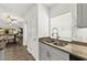 Kitchen view features stainless steel sink and appliances, and granite countertops, open to dining area at 139 Douglas St, Edgewater, FL 32141