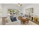 The living room boasts sliding doors to a patio, white furniture, neutral decor, and lots of natural light at 139 Douglas St, Edgewater, FL 32141
