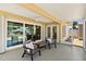 Covered and screened patio with canal view, chairs and table at 139 Douglas St, Edgewater, FL 32141
