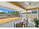 Covered and screened patio with canal view, chairs and table at 139 Douglas St, Edgewater, FL 32141