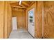 A wooden shed with a concrete floor, interior lighting, and a white exterior door at 139 Douglas St, Edgewater, FL 32141