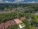 Aerial view of property highlighting the tile roof, mature trees, landscaped yard, and pristine community at 1609 Glen Eagles Way, Orlando, FL 32804