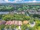 Aerial view of homes surrounded by golf course, blue skies and trees at 1609 Glen Eagles Way, Orlando, FL 32804