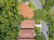 An aerial view of several homes, all featuring terracotta tile roofing in a lush, green surrounding neighborhood at 1609 Glen Eagles Way, Orlando, FL 32804