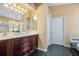 Bathroom features a double sink vanity with dark wood cabinetry, gold fixtures and neutral walls at 1609 Glen Eagles Way, Orlando, FL 32804