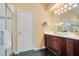 Neutral bathroom with dark wood vanity, double sinks, and gold fixtures at 1609 Glen Eagles Way, Orlando, FL 32804