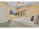Spacious bedroom features double doors leading outside and a decorative ceiling fan at 1609 Glen Eagles Way, Orlando, FL 32804