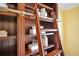 Close-up shot of a built-in bookshelf with a decorative ladder and detailed trim at 1609 Glen Eagles Way, Orlando, FL 32804