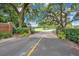 Brick paved entrance to a gated community featuring mature trees, manicured landscaping, and golf course views at 1609 Glen Eagles Way, Orlando, FL 32804