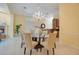 Elegant dining room features a chandelier, glass table, and seating for six at 1609 Glen Eagles Way, Orlando, FL 32804