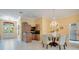 Elegant dining room with a chandelier, a table set for six, and access to the foyer at 1609 Glen Eagles Way, Orlando, FL 32804