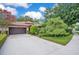 Charming home exterior showcases beautiful landscaping, a spacious driveway, and a terra cotta tiled roof at 1609 Glen Eagles Way, Orlando, FL 32804