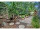 Beautiful garden area with lush plants, stone pavers, and a potting area in this verdant outdoor space at 1609 Glen Eagles Way, Orlando, FL 32804