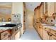 Well-lit kitchen features custom cabinetry, granite counters, and stainless steel appliances at 1609 Glen Eagles Way, Orlando, FL 32804