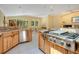 Spacious kitchen area featuring stainless steel appliances and granite countertops, overlooks the living room at 1609 Glen Eagles Way, Orlando, FL 32804