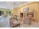 Inviting living room with a fireplace, comfortable seating, and natural light filtering through the windows at 1609 Glen Eagles Way, Orlando, FL 32804