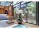 Close up on a sunroom coffee table with a seating area and a fireplace in the background at 1609 Glen Eagles Way, Orlando, FL 32804