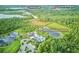 Aerial view featuring the Serenoa Community Clubhouse with a pool, lakes, and natural surroundings at 17426 Saw Palmetto Ave, Clermont, FL 34714