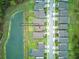 Aerial view of a residential street with a lake nearby, showing the home's location in the community at 17426 Saw Palmetto Ave, Clermont, FL 34714