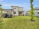Back exterior view of a two-story home featuring a well-manicured backyard and a patio at 17426 Saw Palmetto Ave, Clermont, FL 34714