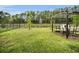 Spacious backyard featuring green grass, fenced perimeter and a serene pond view at 17426 Saw Palmetto Ave, Clermont, FL 34714