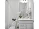 Clean bathroom with a white vanity, modern fixtures, decorative flowers and coordinated towels at 17426 Saw Palmetto Ave, Clermont, FL 34714