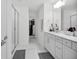 A spacious bathroom with dual vanities, a glass-enclosed shower, and marble-like floors at 17426 Saw Palmetto Ave, Clermont, FL 34714