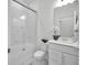 Clean bathroom featuring a glass-enclosed shower, white vanity, modern toilet and decorative plant at 17426 Saw Palmetto Ave, Clermont, FL 34714