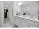 A spacious bathroom with dual vanities, a glass-enclosed shower, and marble-like floors at 17426 Saw Palmetto Ave, Clermont, FL 34714