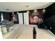 Spacious bonus room features fun movie decor, and comfortable seating at 17426 Saw Palmetto Ave, Clermont, FL 34714