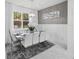Elegant dining room with large window, decorative mirror, white table set for six and modern chandelier at 17426 Saw Palmetto Ave, Clermont, FL 34714