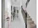 Inviting foyer with marble floors, decorative accents, and staircase with metal railings at 17426 Saw Palmetto Ave, Clermont, FL 34714