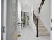 Elegant foyer with marble floors, decorative table with flowers, and staircase at 17426 Saw Palmetto Ave, Clermont, FL 34714