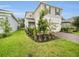 Lovely two-story home with a two-car garage and a beautifully landscaped front yard with manicured grass at 17426 Saw Palmetto Ave, Clermont, FL 34714