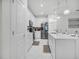 Modern kitchen with white cabinetry, stainless steel appliances, marble floors and pendant lighting at 17426 Saw Palmetto Ave, Clermont, FL 34714