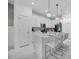 Bright kitchen with white cabinets, stainless appliances, large island with bar seating, and pendant lights at 17426 Saw Palmetto Ave, Clermont, FL 34714
