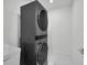 Modern laundry room with stacked washer and dryer and sleek design at 17426 Saw Palmetto Ave, Clermont, FL 34714